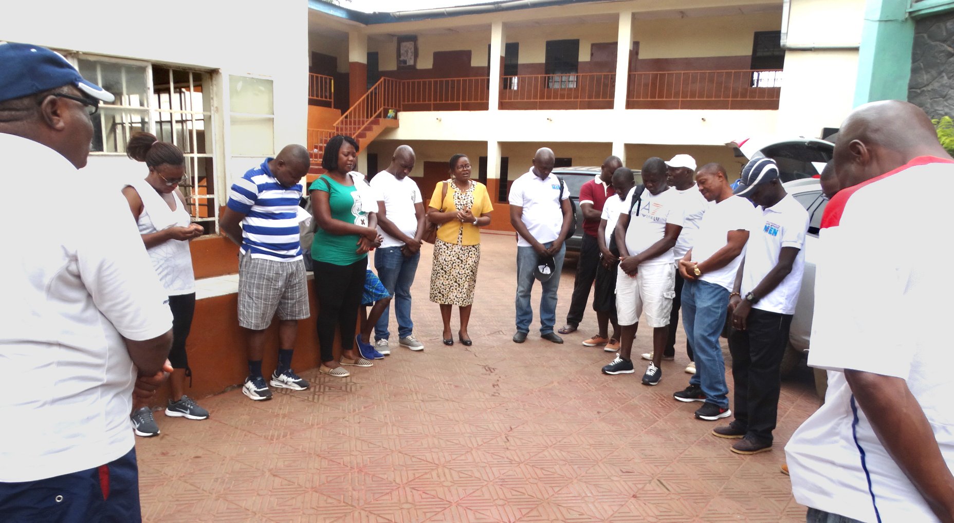 The Rev. Daisy Gbloh (center), lead pastor of Bishop Baughman United Methodist Church, leads a group in prayer before leaving on a “Waka For Jesus” evangelism walk across western Freetown, Sierra Leone. The group traveled on foot through the metropolis on April 14 sharing messages of peace. This was the first time the local church organized an evangelism event of this nature. Photo by Phileas Jusu, UMNS.