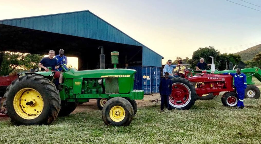 Zimbabwean and American friends pose with farm equipment at the Mutambara Mission. Photo courtesy of Mutambara Mission.