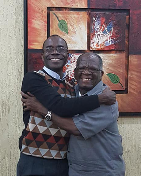 The Rev. Daniel Mhone, left, and the Rev. Maxwell Jawati embrace negotiations that could bring a new era of peace for the Malawi United Methodist Church. Photo courtesy of Alfiado Zunguza.