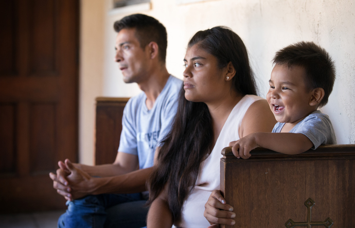 One-year-old Jose Antonio smiles while his mother and father Irlanda Lizbeth Jimenez Rodriguez and Jose Antonio Marchas Novela recall the threats of violence that caused them to leave Mexico and seek asylum in the U.S. Photo by Mike DuBose, UMNS.