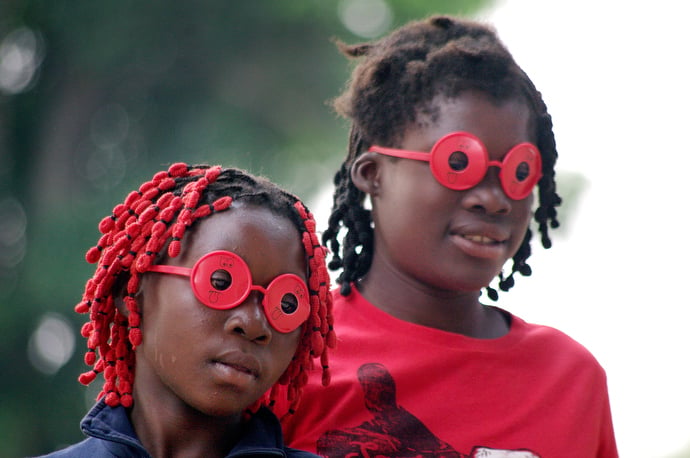 Children at Quessua Mission play with toy glasses donated by volunteers from the Florida Conference of The United Methodist Church. Photo by the Rev. Gustavo Vasquez, UMNS.