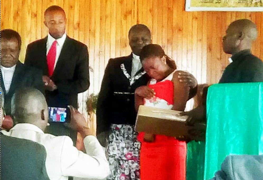 Rejoice Mushayi, a first-year student at Great Zimbabwe University in Masvingo, receives a laptop from United Methodist leadership in the Masvingo District. Mushayi also was given a scholarship worth more than $2,000 for her first two semesters. Photo courtesy of Fungai Mutambara.