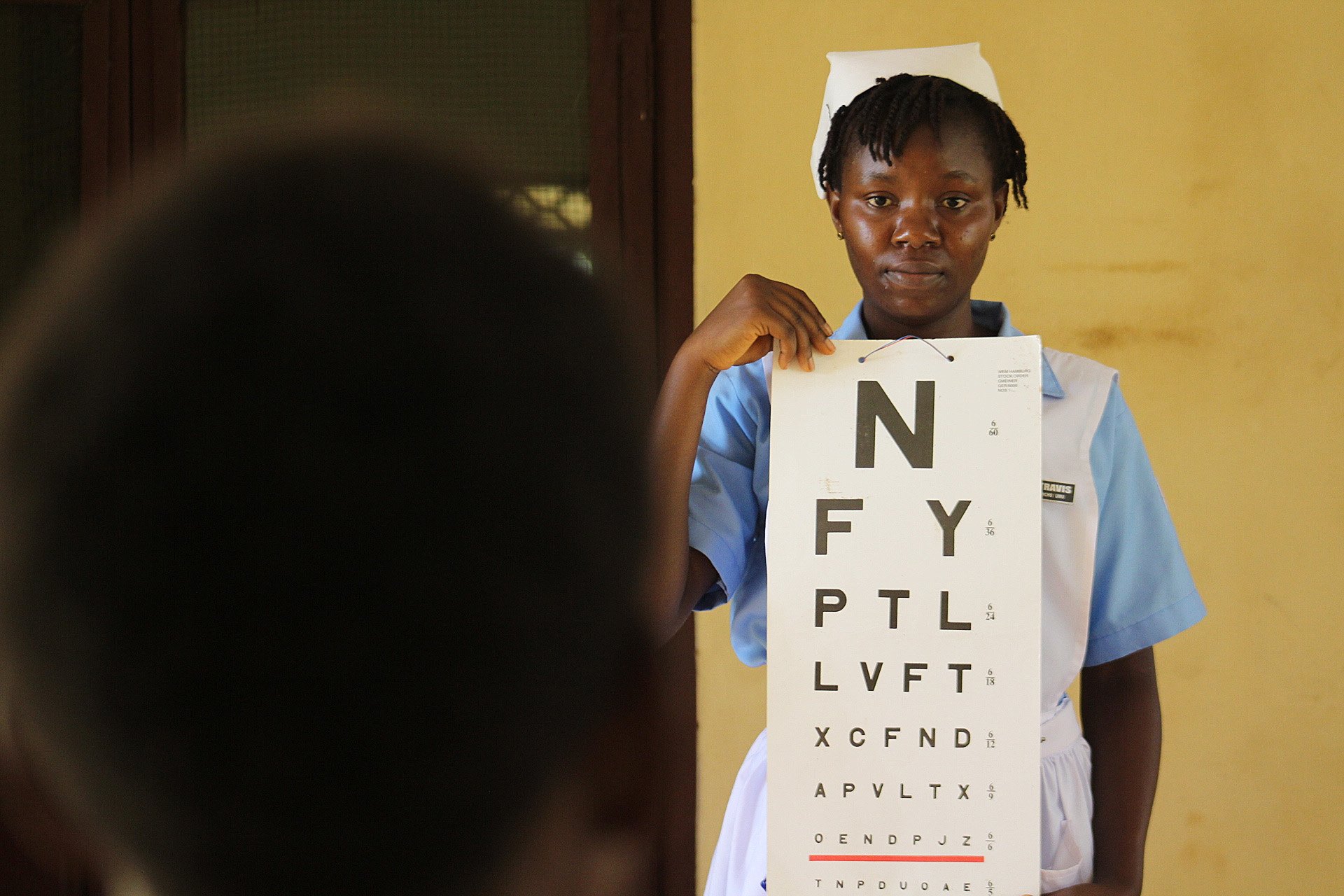 John Togba from the Jorquelleh District takes an eye screening test at Ganta Hospital in Nimba County, Liberia. Photo by E Julu Swen, UMNS.