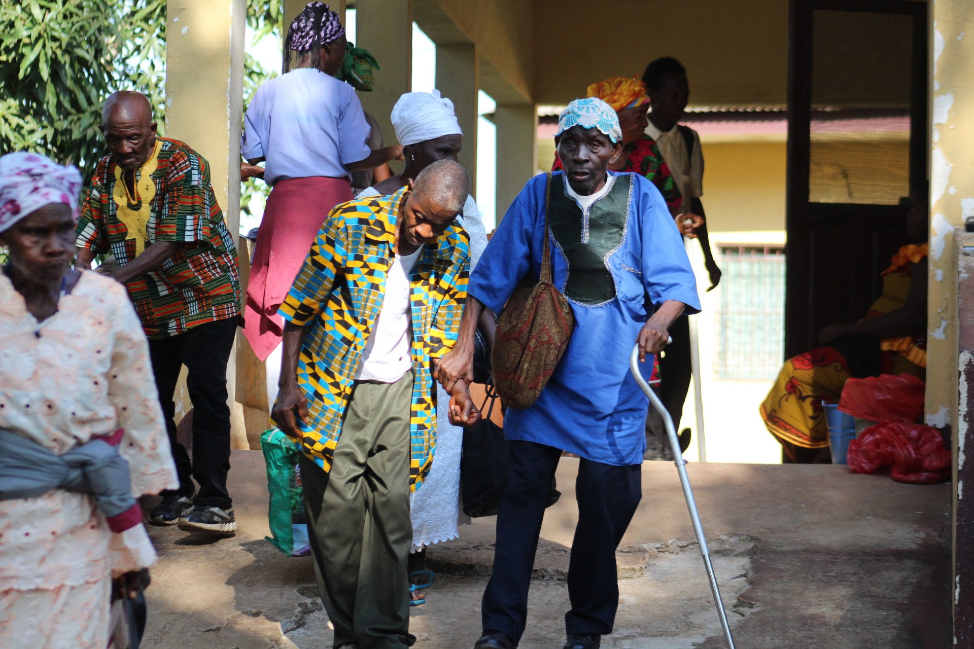 Student Louise Travis helps screen the vision of John Togba at Ganta Hospital in Liberia. Photo by E Julu Swen, UMNS.