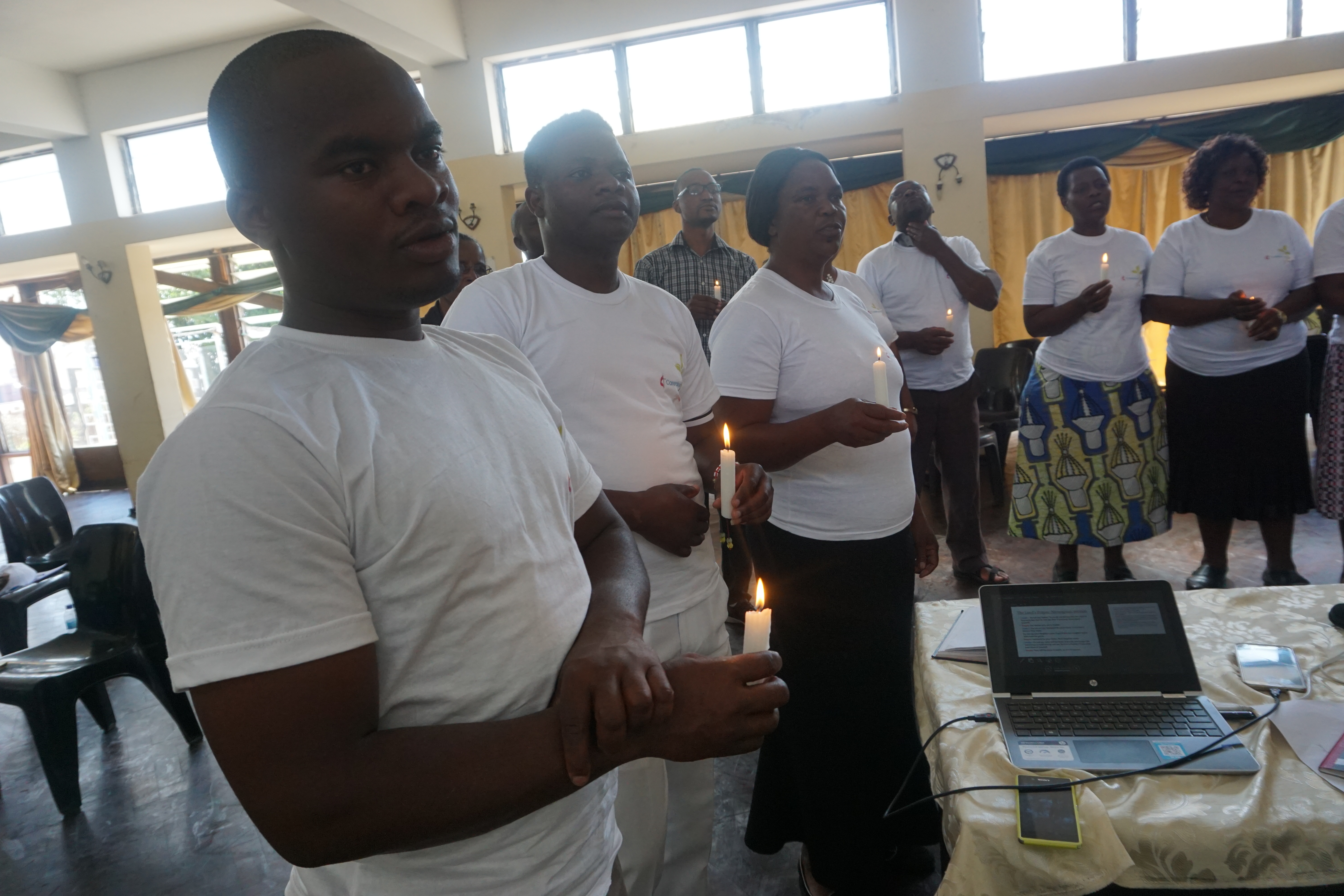 Training participants hold candles and recite the Lord’s Prayer at the end of eco-congregation training in Mutare, Zimbabwe. Photo by Kudzai Chingwe, UMNS. 