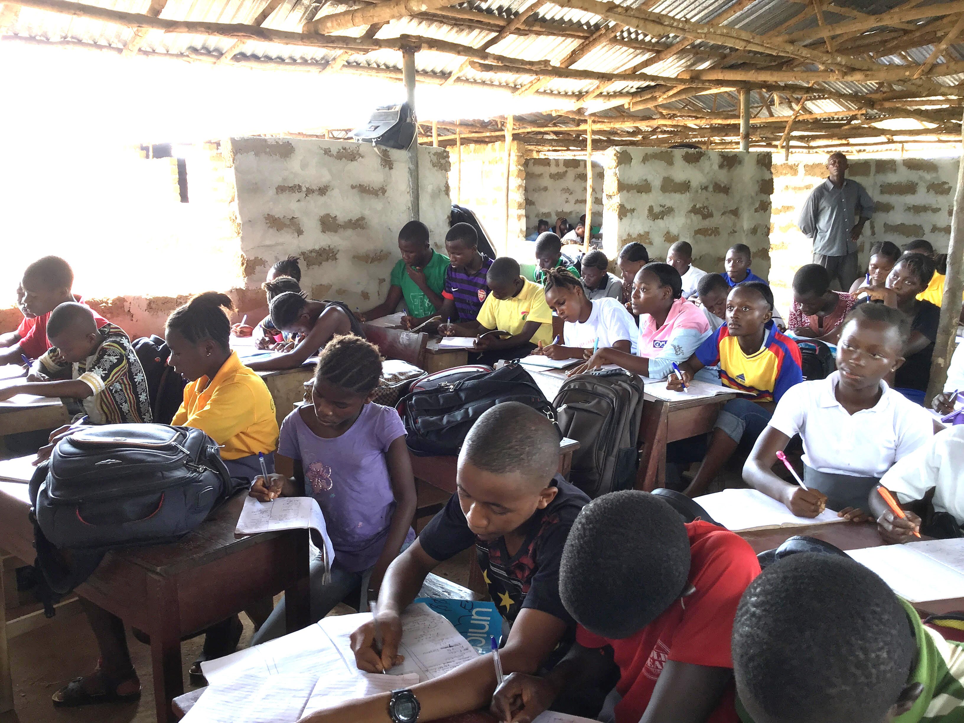 Pupils of Sir Milton Margai Junior Secondary School in Gbangbatoke, Sierra Leone, squeeze into an unfinished building. The United Methodist school has yet to be approved for government funding under the new free education program, but school leaders hope that will happen soon. Photo by Phileas Jusu, UMNS.