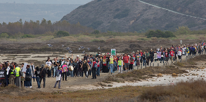 Faith leaders and supporters of immigrant rights march for migrant justice at Border Field State Park in San Diego. Photo by Mike DuBose, UMNS.