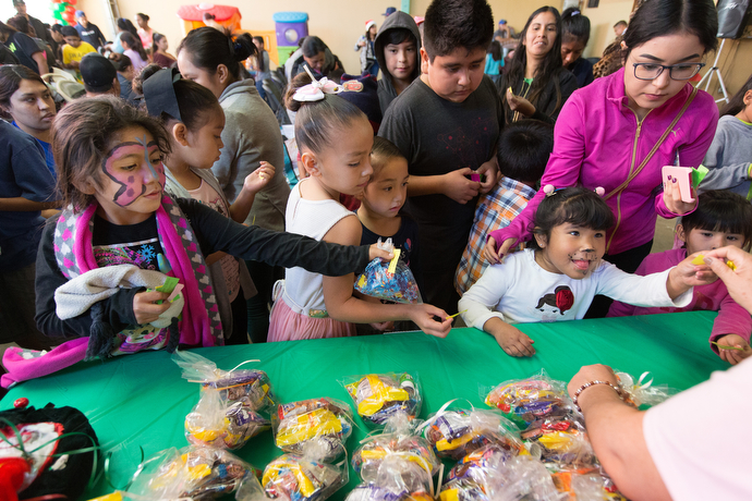 Children line up for treat bags at the Christmas party.