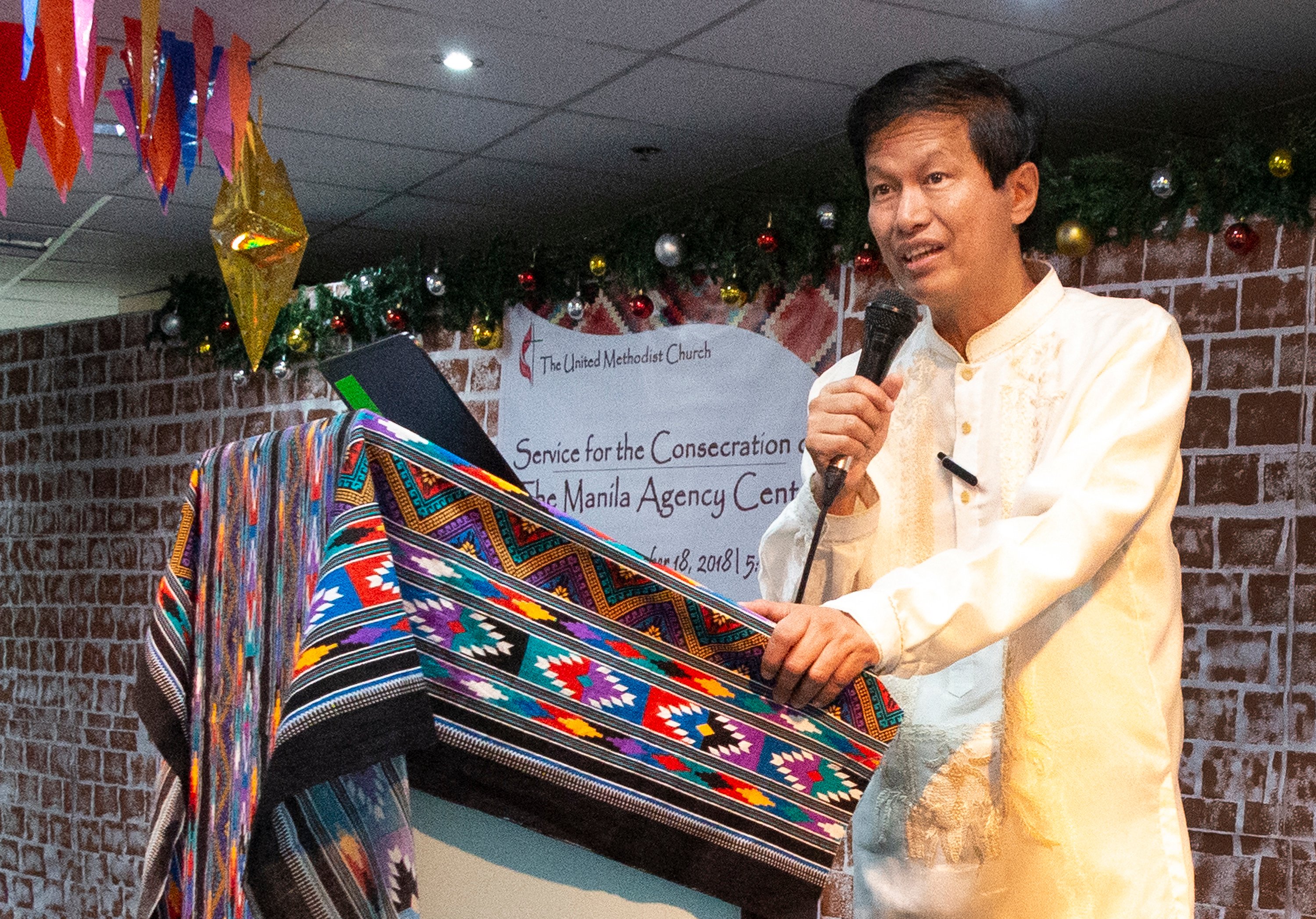 Bishop Pedro M. Torio Jr. addresses the gathering from the podium. Photo by Tim Tanton, UMNS.