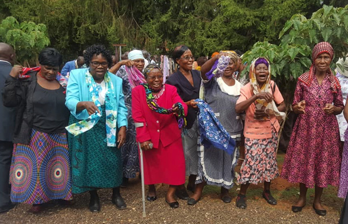 Women in Bulawayo, Zimbabwe, show off the new scarves they received as gifts from The United Methodist Church. More than 100 senior citizens received free health consultations and treatment during a medical outreach program and Christmas party to commemorate Elderly Day. Photo by Kudzai Chingwe, UMNS.