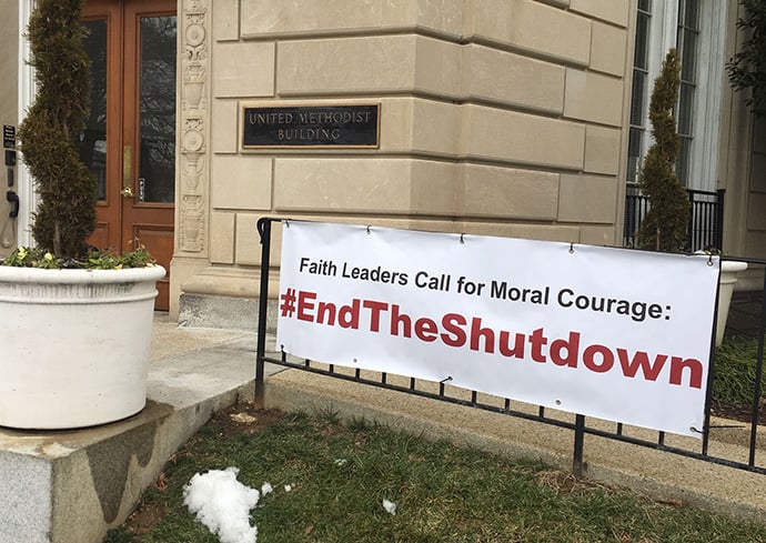 A sign calling for the end of the government shutdown is posted outside the United Methodist Building during day 2  of the shutdown. Photo by Melissa Lauber, Baltimore-Washington Conference.