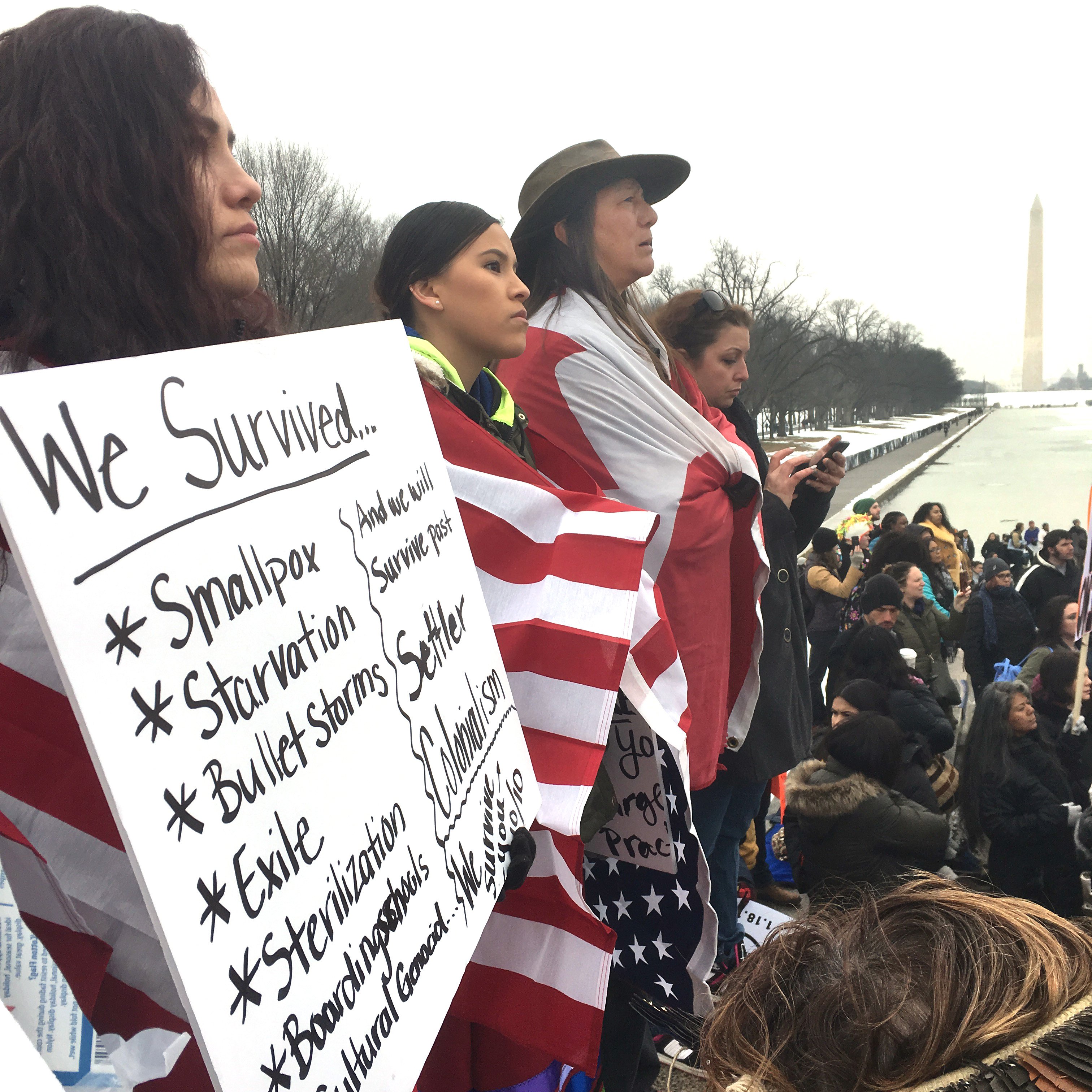 Standing at the front steps of the Lincoln Memorial, women wrapped in flags hold signs during the Indigenous Peoples March held Jan. 18 in Washington, D.C. UMNS photo by Erik Alsgaard, Baltimore-Washington Conference.