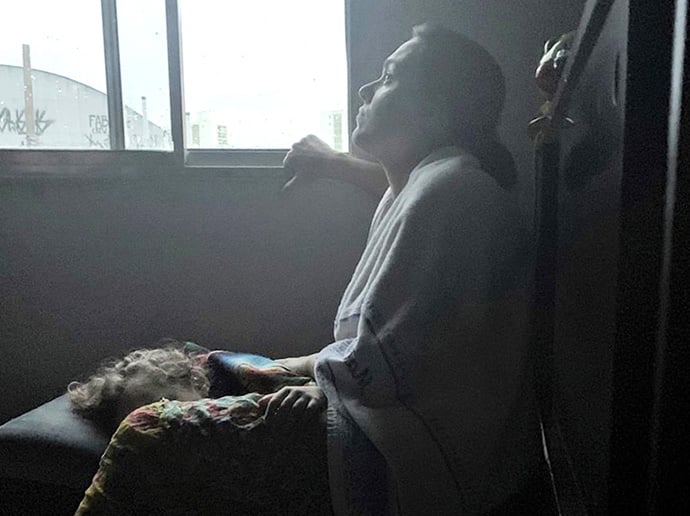 Juliana Melito sits with her child at dawn after seeking refuge from flooding in a Brazil home on March 10. Photo courtesy of Scott Gilpin.