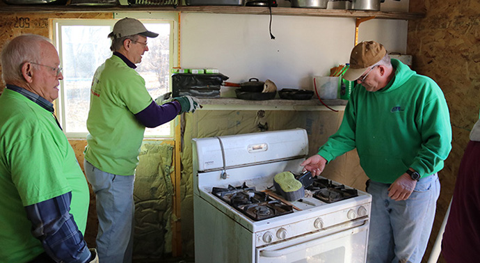 Members of the Great Plains Conference early response team clear flood damaged items from a home in North Loup, Nebraska. Photo courtesy of the Great Plains Conference.