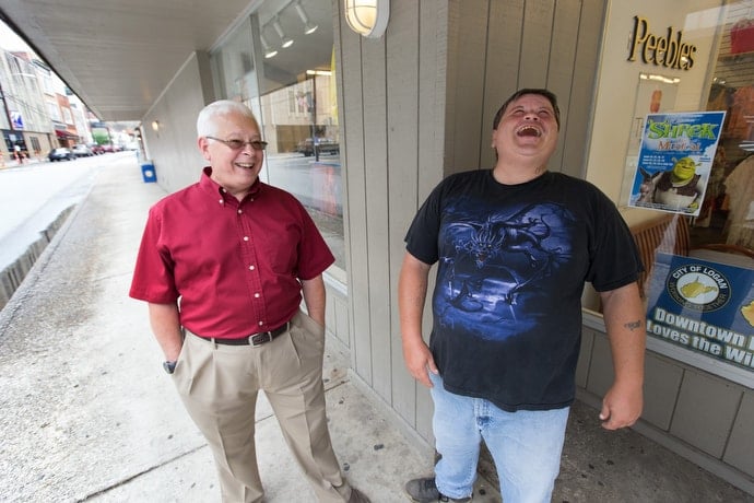 The Rev. Mike Smith (left) visits with Nevada on the street near Nighbert United Methodist Church in Logan, W.Va. Photo by Mike DuBose, UMNS.