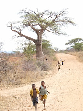 Children run down a road toward Hanwa Mission School in Hanwa, Zimbabwe. The school is now officially a United Methodist school. File photo by Chenayi Kumuterera, UMNS. 