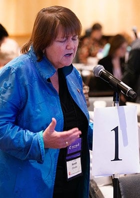 Bishop Karen Oliveto leads the Council of Bishops in prayer following the deadly school shooting in Denver suburb. Oliveto leads the Mountain Sky Conference, where the attack occurred. Photo by the Rev. Todd Rossnagel, Louisiana Conference.