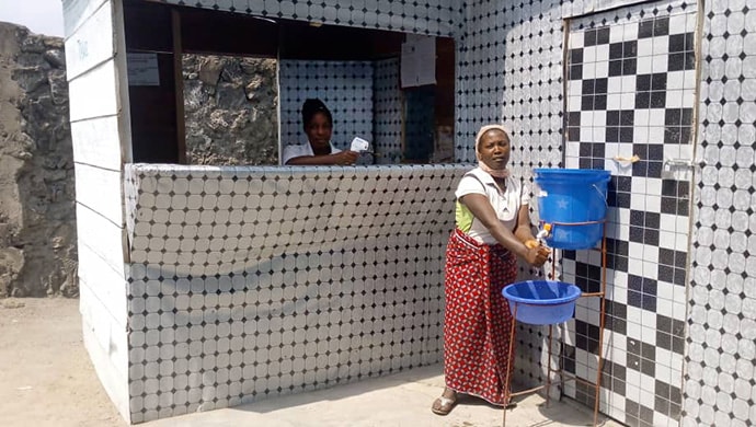 A patient goes through a triage zone at Goma Methodist Health Center which involves hand-washing and temperature check. Photo by Philippe Kituka Lolonga, UM News.