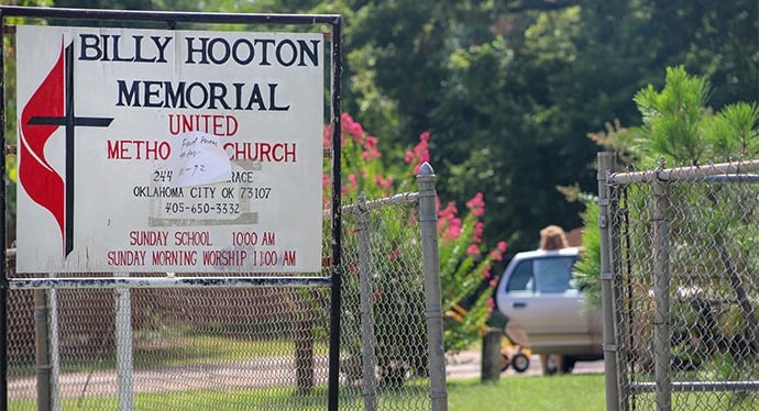 A handwritten note placed on the front sign of Billy Hooton United Methodist Church in the Oklahoma Indian Missionary Conference lets participants know when food will be distributed. Photo by Ginny Underwood, UM News. 