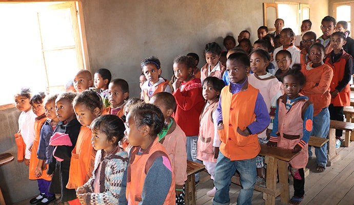 Students stand to recognize a visitor at the Alpha Primary School, located in a poor urban area of Antananarivo, Madagascar. The school serves as a gathering place for one of two new United Methodist communities in the country.  Photo by João Filimone Sambo, UM News.