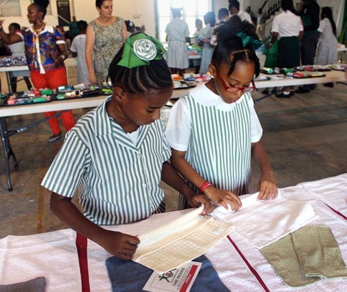 Students and teachers at Queen’s College in Nassau, Bahamas, assemble hygiene kits for those in need on Grand Bahama and Abaco islands following Hurricane Dorian. Photo courtesy of Queen’s College. 