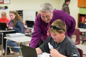 The Rev. Michael Funkhouser visits with student Jeremy Griffith at East Hardy Early Middle School in Baker, W.Va. Funkhouser is West Virginia's 2013 teacher of the year. Photo by Mike DuBose, UM News.