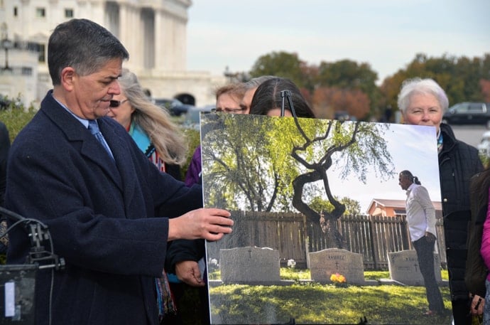 U.S. Rep. Filemon Vela, a Texas Democrat, adjusts a photo of Jackson Chapel United Methodist Church’s historic cemetery in San Juan, Texas, during a press conference protesting President Trump’s proposed border wall. Photo by Erik Alsgaard, UM News.