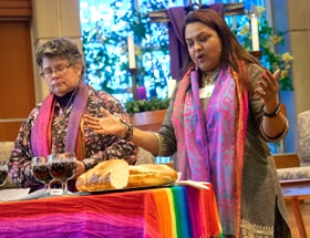 The Revs. Martha E. Vink and Alka Lyall officiate at the Holy Communion service at the Advent Gathering organized by UM-Forward and Methodists in New Directions. The Dec. 3-4 gathering at St. Andrew United Methodist Church in Highlands Ranch, Colo., aimed to work toward a fully inclusive form of Methodism. Photo by Joy Butler, UM-Forward.