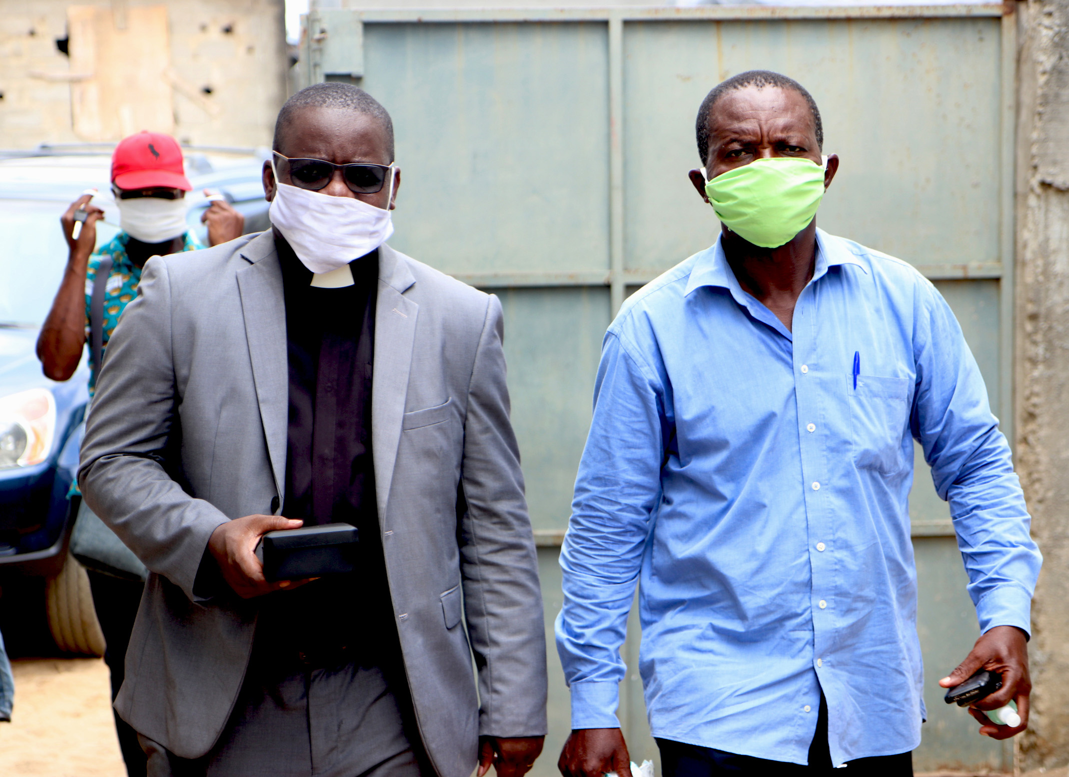 The Rev. Isaac Broune (left), pastor of Bethel Quartier-Eléphant, and Jacob N’Guessan, a United Methodist class leader, travel in the outskirts of Quartier-Eléphant to visit members in their homes to fellowship and give them communion. Gatherings with fewer than 50 people are allowed as long as social distancing is maintained and masks are worn. Photo by John Mel, UM News.