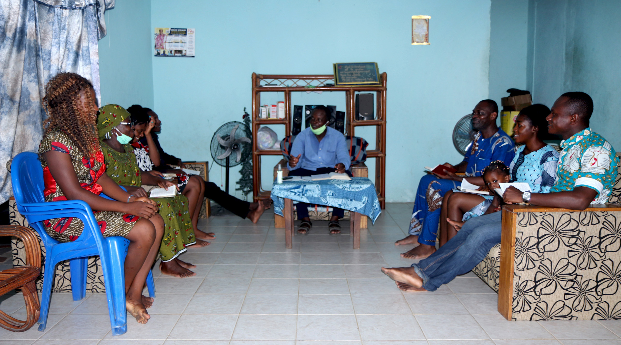 Jacob N’Guessan (blue shirt), a United Methodist class leader at Bethel Quartier-Eléphant United Methodist Church, leads a home service with his family. While churches are closed because of the COVID-19 pandemic, members are conducting services at home with resources provided by their pastors. Photo by John Mel, UM News.