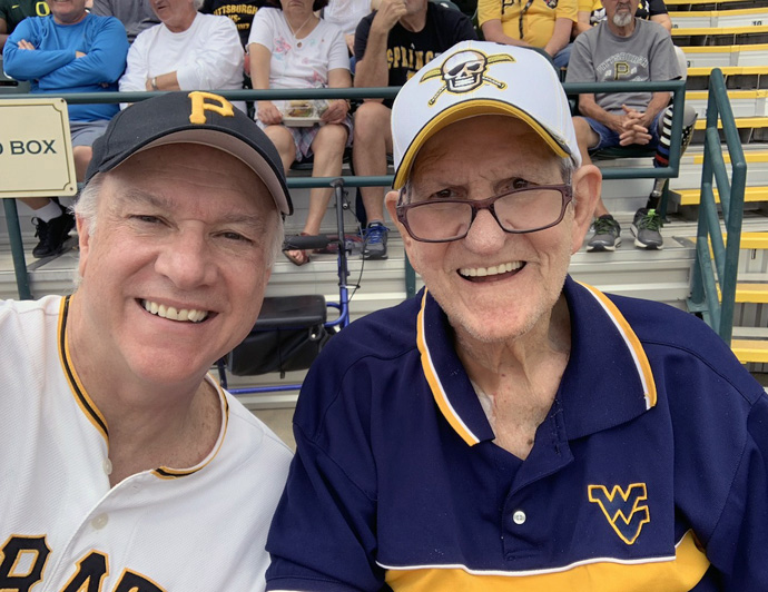 New York Conference Bishop Thomas Bickerton (left)  with his father, Jim Bickerton, at a Pittsburgh Pirate spring training game in Bradenton, Fla., in 2019. Jim Bickerton, 84, contracted the coronavirus in his Florida nursing home/rehabilitation center in mid-April but has lately tested negative for the disease. Photo courtesy of Bishop Bickerton.