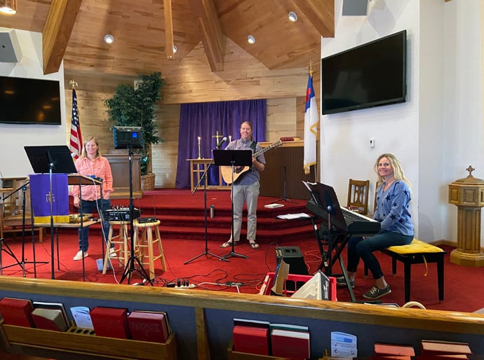 (From left) Pastor Molly Fiore, guitarist Matt Miller and keyboard player Jenny Roussel sit among audio and recording equipment in United Methodist Church of Eagle Valley in Eagle, Colo. Photo courtesy of United Methodist Church of Eagle Valley.