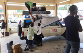 Workers with the church's Department of Community Services load supplies onto a vehicle to deliver to rural Liberia. The food relief — supported by UMCOR and other global partners — is part of the efforts of The United Methodist Church's Anti COVID-19 Taskforce. Photo by E Julu Swen, UM News.