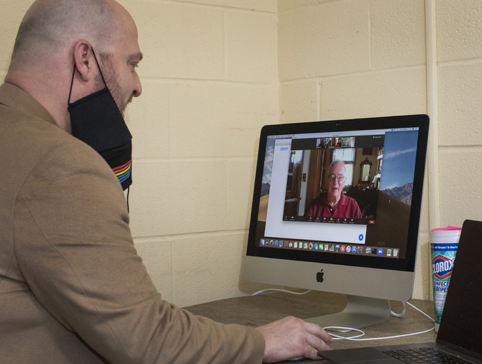 Joe Lee, music director at East End United Methodist Church in Nashville, Tenn., talks with COVID-19 survivor and choir member Carl Zehner, using ZOOM. Zehner nearly died from the virus and had a happy virtual reunion with Lee and choir members on July 12. Photo by Kathleen Barry, UM News. 