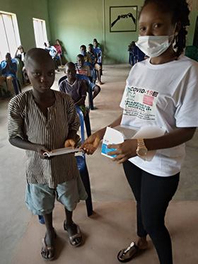 Jenifer Philip, a Young Africa Leadership Development member, distributes face masks to children at the church’s orphanage in Jalingo, Nigeria. Photo courtesy of Peter Cibuabua, Young Africa Leadership Development.