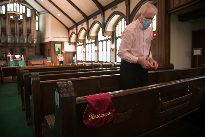 Steve Haney checks seating restrictions for the Sunday, June 14 worship service at Laurel Heights United Methodist Church, in San Antonio. Haney, who teaches at the UT Health San Antonio Dental School, serves on a COVID-19 team at the church that has come up with criteria and even a color-coded chart to guide decisions on opening and closing. Laurel Heights closed again for in-person worship the following Sunday and remains closed due to high COVID-19 case numbers in the area. Photo by David Smith, courtesy of Laurel Heights United Methodist Church.