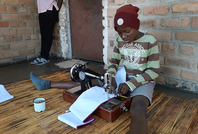 Fortune Muchatuki, a grade seven student at The United Methodist Church’s Hanwa Mission Center primary school in Macheke, Zimbabwe, sews a face mask.  A recent $3,000 donation from the Baltimore-Washington Conference’s Zimbabwe Volunteers in Mission team provided material for face masks, food and other necessities. Photo by Kudzai Chingwe, UM News.