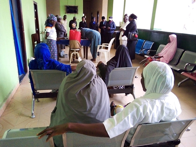 United Methodist clergywomen pray with patients and staff at Primary Health Care Center, a government-run maternity clinic in Karim Lamido, Nigiera, during an outreach visit in July. Photo by Ramson Danjuma.