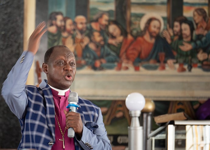 Bishop John K. Yambasu presides over a session of the Sierra Leone Conference meeting in Koidu City, Sierra Leone. Delegates endorsed a plan of amicable separation for The United Methodist Church and voted to send it to General Conference in May. Photo by Kathy L. Gilbert, UM News.  