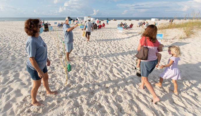 Greeters Diane and Darryl Bunch (left) welcome worshippers to the Galilean Beach Service. Photo by Mike DuBose, UM News.