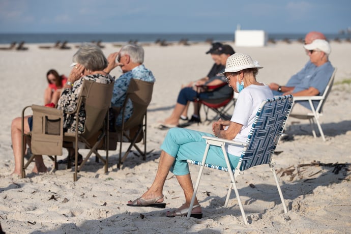 Marion Bethea (front) joins other worshippers in prayer during the Galilean Beach Service. She has regularly attended the outdoor service since 1994. Photo by Mike DuBose, UM News.