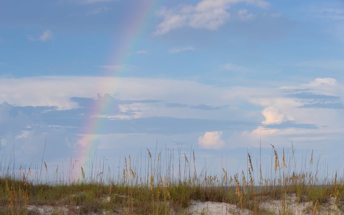 A rainbow arcs across the sky at Gulf State Park in Gulf Shores, Ala., just prior to the start of the Galilean Beach Service. Photo by Mike DuBose, UM News.