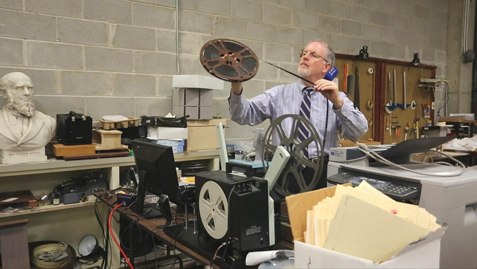 L. Dale Patterson, the now-retired archivist-records administrator at the United Methodist Commission on Archives and History, examines film, one of thousands of carefully filed items at the agency housed on the campus of Drew University in Madison, New Jersey. 2013 file photo by Kathleen Barry, UM News.