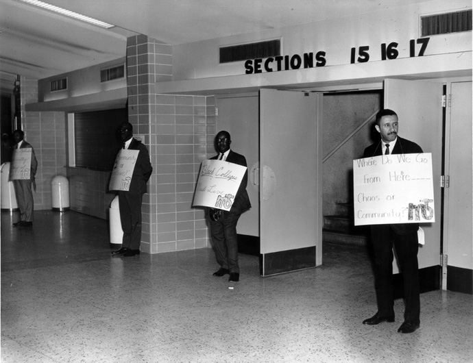 “Where do we go from here … Chaos or Community?” appears on the sign held by the Rev. Gil Caldwell by the entrance to the 1968 Uniting Conference in Dallas. The gathering officially formed The United Methodist Church and ended the segregated Central Jurisdiction. Caldwell used the title of the Rev. Martin Luther King Jr.’s final book to remind delegates of the church's ongoing call to confront racism. Photo courtesy of Archives and History.