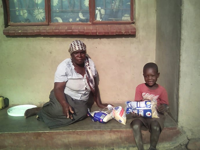 United Methodist Ruseni Yeni and her 6-year-old great-grandson, Junior, depend on well-wishers to get by during the COVID-19 pandemic. They were among the recipients of food aid distributed by The United Methodist Church in the Harare East District of Zimbabwe. Photo by Kudzai Chingwe, UM News.