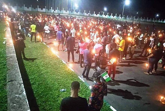 Protesters at the Ahmadu Bello Way in Jos, Nigeria, hold candles and chant liberation songs on Oct. 20. At least 56 people have died since the protests against police brutality began on Oct. 8, according to Amnesty International. Photo by the Rev. Christopher Thomas