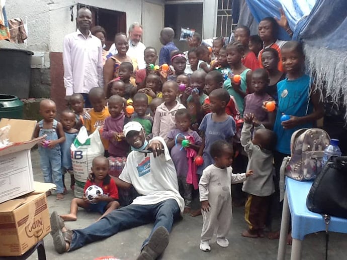 United Methodist missionary Innocent Phrytoil Afful and children from the Kinkole Orphanage display gifts they received from a donor. Afful helps care for 475 children at the orphanage in Kinshasa, Congo. Photo courtesy of Innocent Phrytoil Afful.