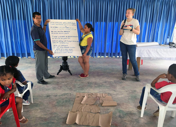 Hannah Reasoner (in white T-shirt facing camera) instructs children as part of her duties as a missionary in Colombia. Photo courtesy of Hannah Reasoner.