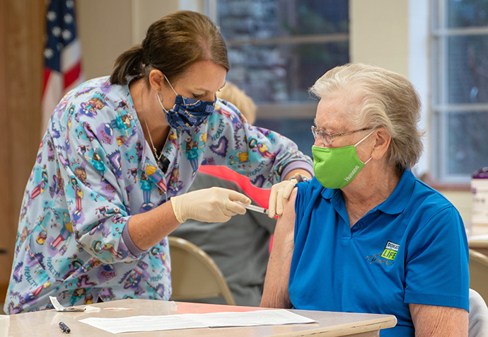 Ruth Prior receives her first dose of the Moderna COVID-19 vaccine at Hermann (Mo.) United Methodist Church, where she is a member. The vaccine is being administered by Kelly Thompson, LPN, from the Gasconade County Health Department. Photo by the Rev. John Hampton.