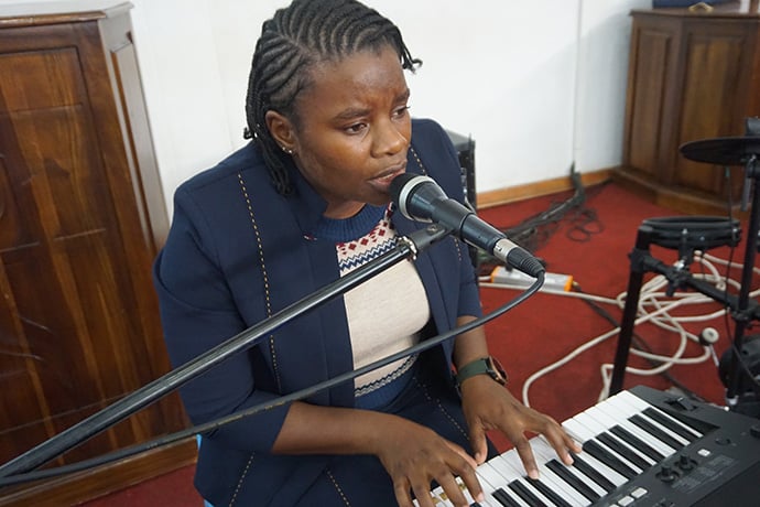 Christine Anesu Hove records music for an online worship service at Chisipiti United Methodist Church in Harare, Zimbabwe. “I eat, breathe and speak music,” Hove said, “and that is how I am fulfilling my calling during this COVID-19 pandemic.” Photo by Kudzai Chingwe, UM News.